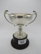 Large Art Nouveau twin handled sterling silver trophy on a Bakelite plinth. No inscription,