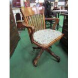 Early 20th century oak swivel chair on castors. Estimate £30-40