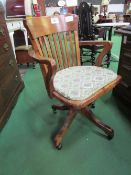 Early 20th century oak swivel chair on castors. Estimate £30-40