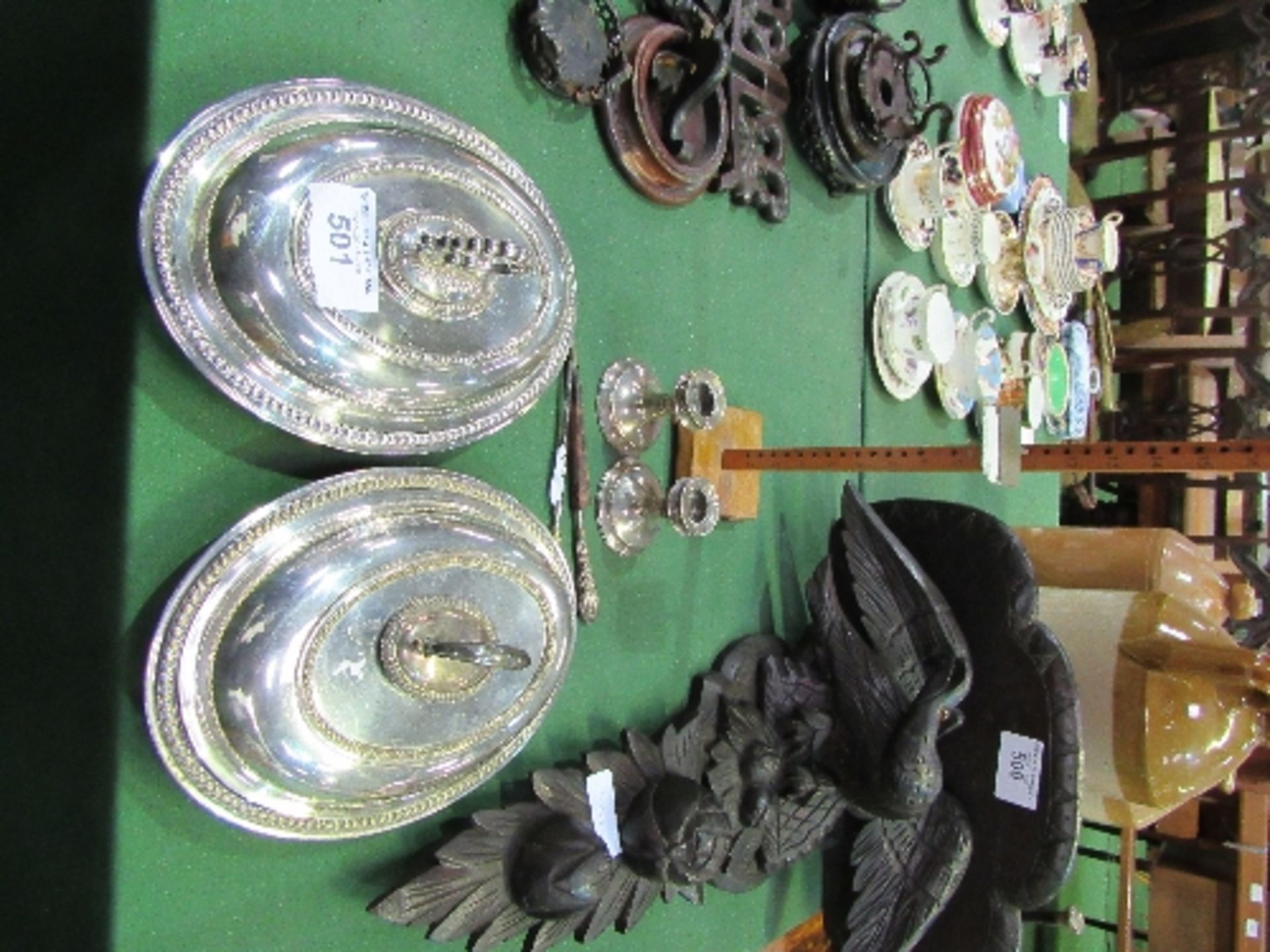 A pair of silver plated covered serving dishes; a pair of low silver candlesticks (a/f); silver