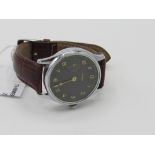 Vintage hand-winding wristwatch (converted from pocket watch) with glass back showing Omega