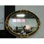 Gilt framed oval shaped wall mirror, 64 x 84cms. Estimate £20-30