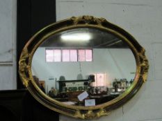 Gilt framed oval shaped wall mirror, 64 x 84cms. Estimate £20-30