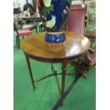 Yew wood circular occasional table on fine tapered legs to casters, diameter 68cms. Estimate £20-40
