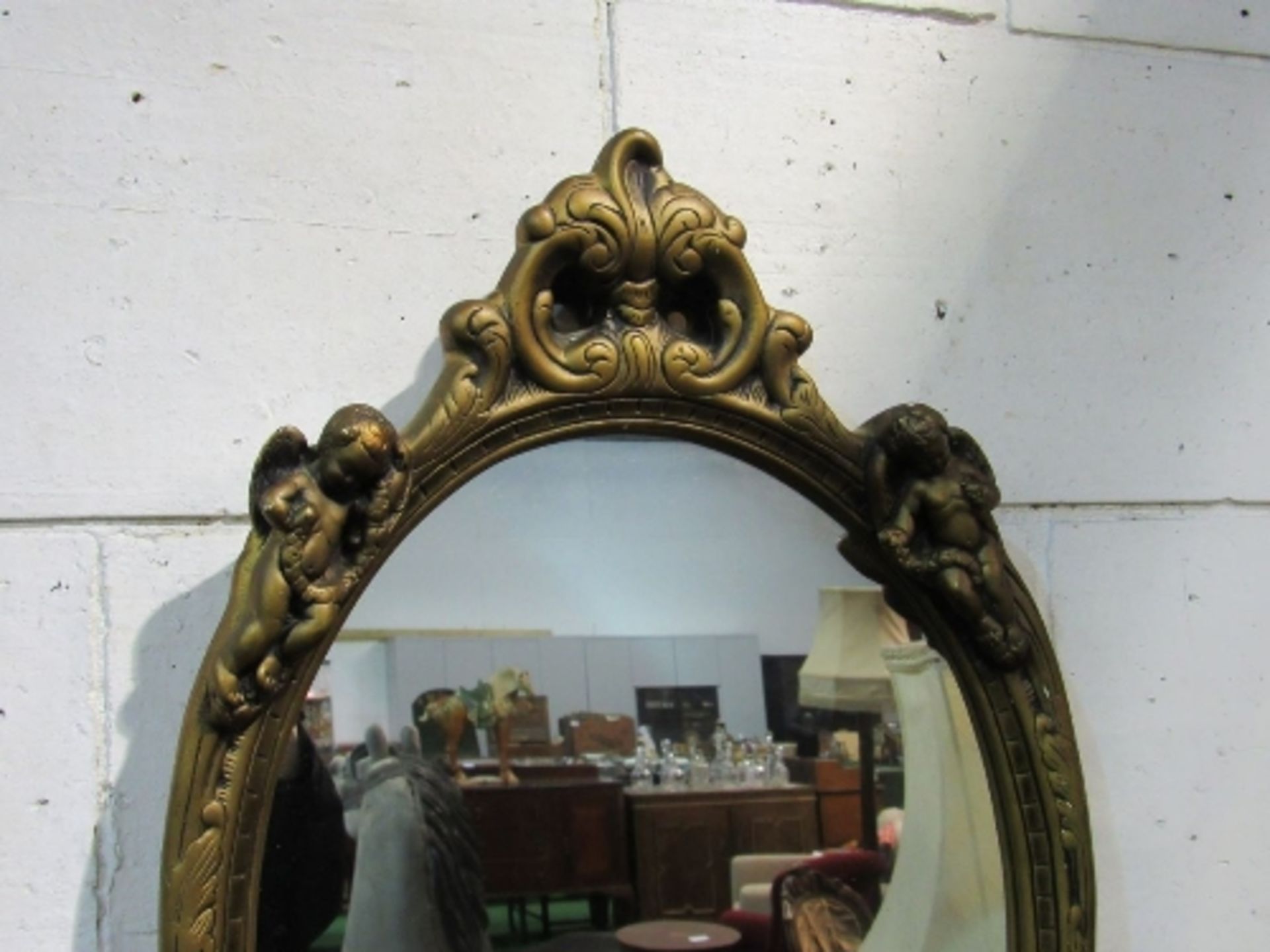 Oval wall mirror in gilt frame, decorated with putti, 69 x 44. Estimate £20-30 - Image 2 of 2