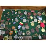 Wooden display case containing a variety of medals & badges. Estimate £20-30