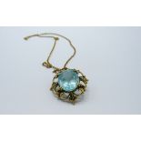 Aquamarine stone set in 9ct gold on a yellow metal chain, weight 6.4gms. Estimate £350-380