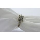 18ct white gold ring set with 9 diamonds in square with diamonds to shoulder, weight 3.8gms, size P.