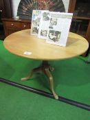 Circular hardwood tilt-top table on pedestal, 98cms diameter x 76cms. Estimate £20-40