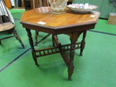 Mahogany octagonal table with cross stretchers, on casters, 86 x 80 x 71cms. Estimate £25-50