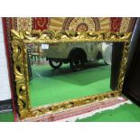 Gilt scroll-decorated wall mirror, 95 x 142cms. Estimate £30-50