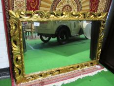 Gilt scroll-decorated wall mirror, 95 x 142cms. Estimate £30-50