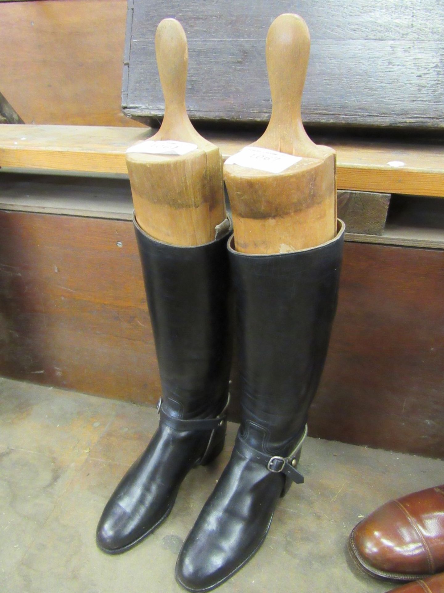 A pair of black riding boots with trees