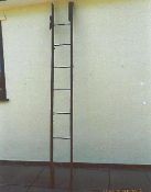 Three-fold wood and metal coaching ladder (view in security pen)