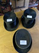 Three top hats of various sizes