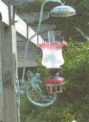 Angel lamp with ruby coloured glass oil reservoir, etched fluted shade and a glass funnel, supported