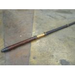 An unusual Dealer's whip with a leather-covered malacca handle and a black glazed threaded shaft