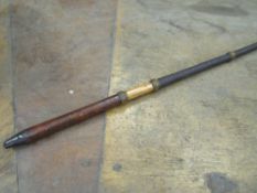 An unusual Dealer's whip with a leather-covered malacca handle and a black glazed threaded shaft