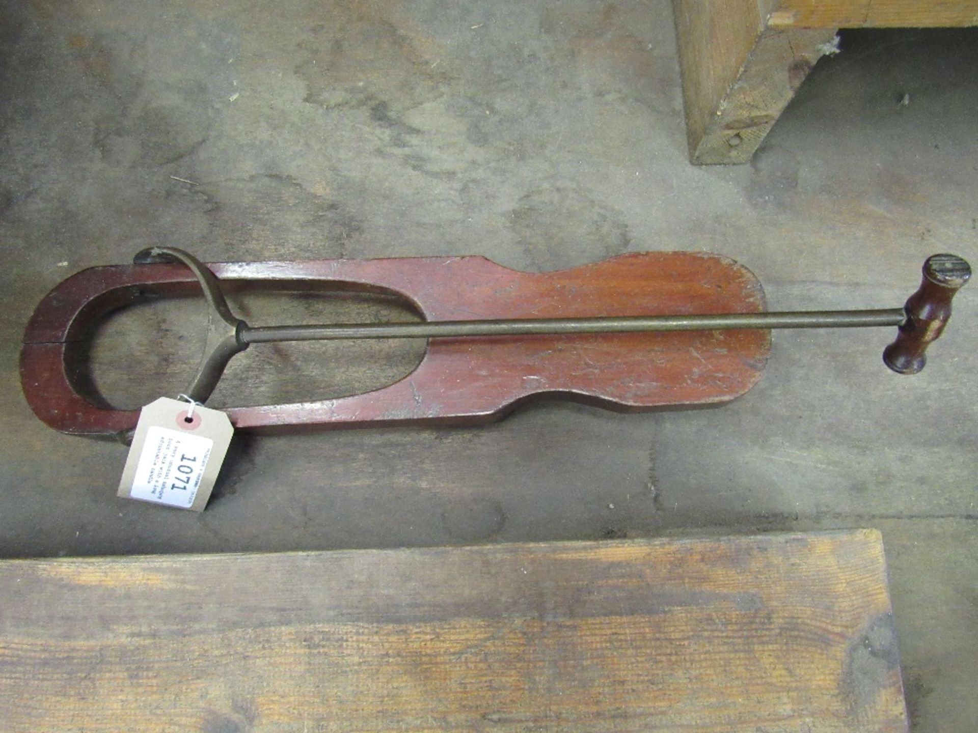 A very unusual mahogany boot jack with a long adjustable handle