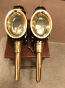 A pair of good quality oval fronted black/brass carriage lamps