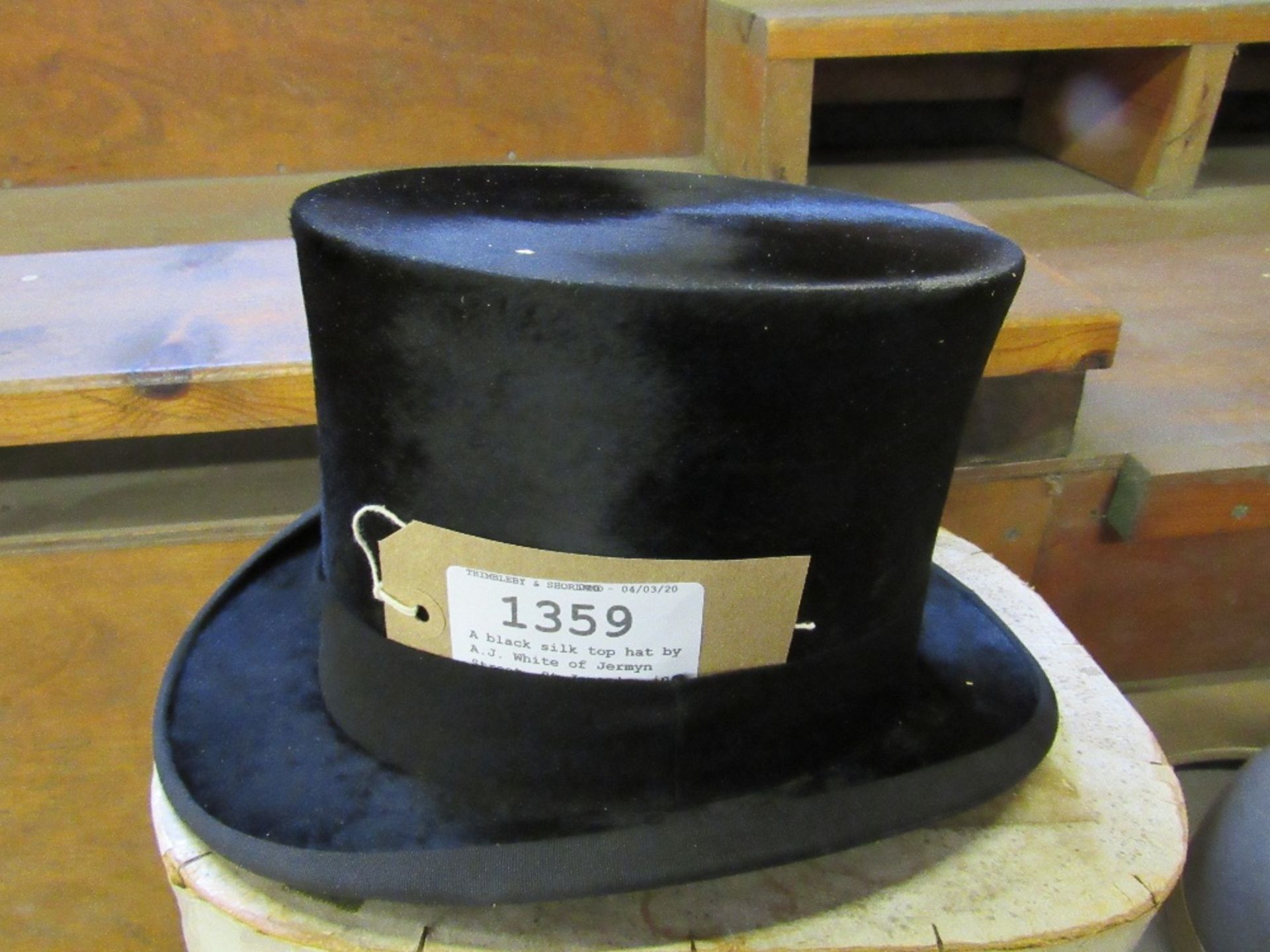 A black silk top hat by A.J. White of Jermyn Street, St James's, in its original cardboard box