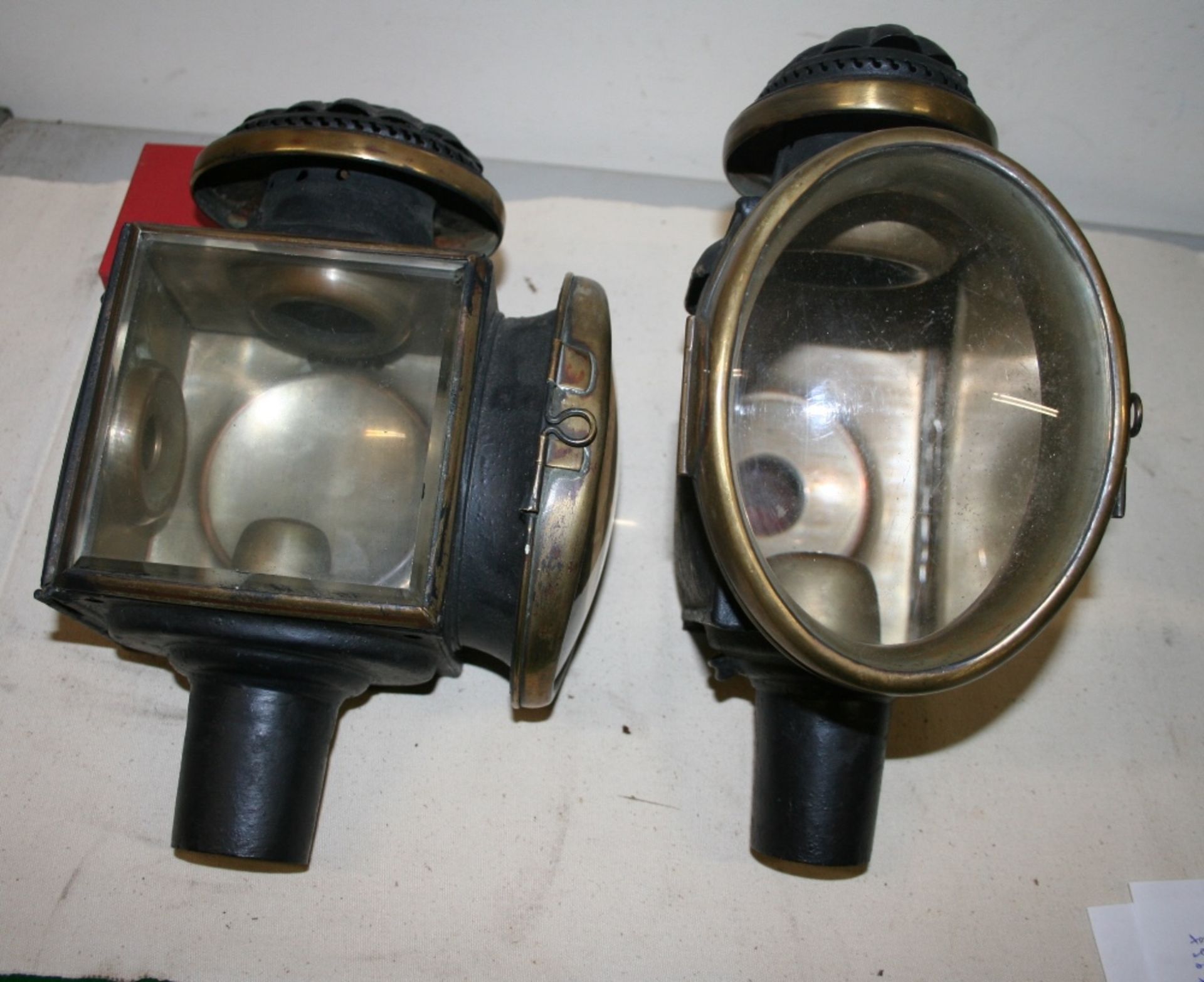 Pair of oval fronted carriage lamps with magnified lenses (view in security pen)