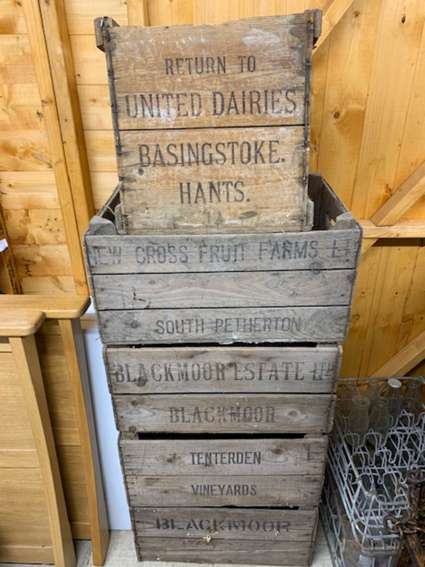4 wooden apple boxes and 1 United Dairies 'Basingstoke' box