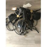 Five assorted leather driving bridles