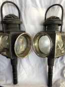 Pair of unusual black/brass trade lamps with round fronts and carry handles (view in security pen)