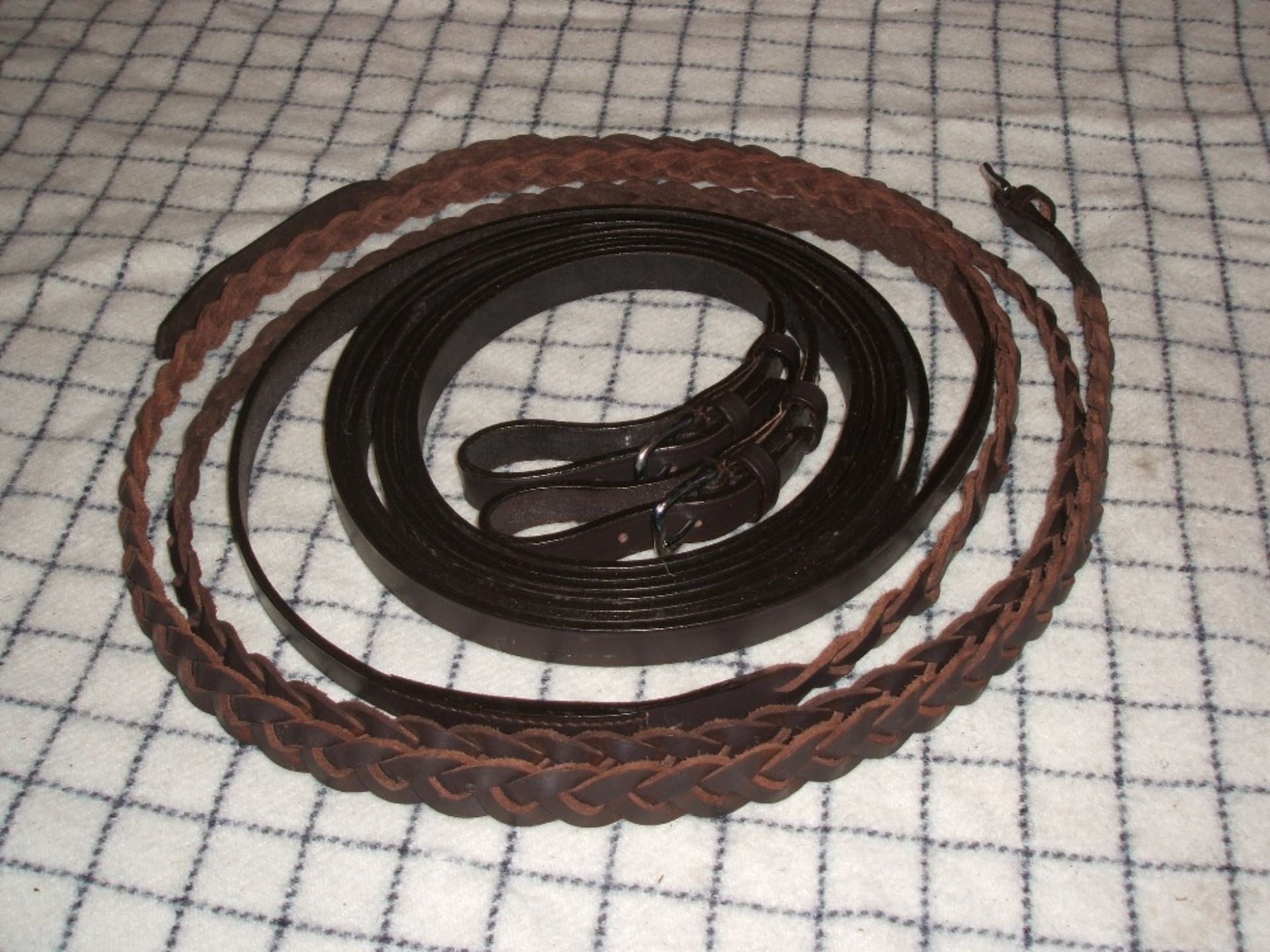 Pair of cob size brown/whitemetal plaited driving reins