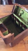 In exceptional condition, an antique travelling case with green silk-effect lining, containing