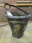 A fine and heavily crested fire bucket complete with a leather handle, inscribed with a motto '