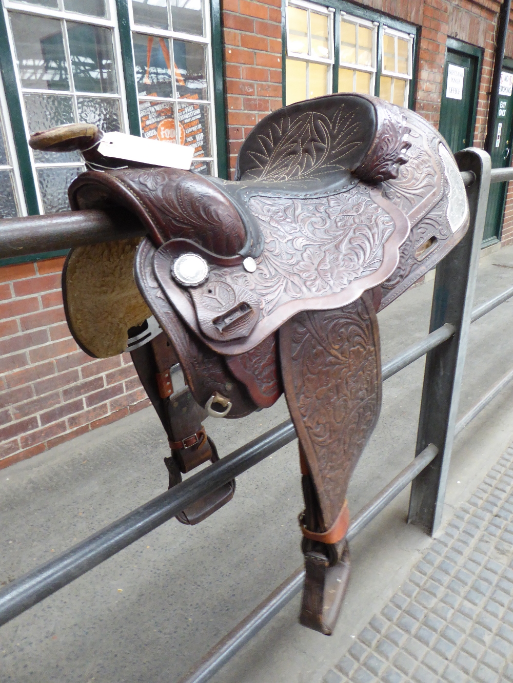 Full size brown leather Western saddle made in Wyoming, USA with decorative stitching and whitemetal