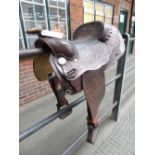 Full size brown leather Western saddle made in Wyoming, USA with decorative stitching and whitemetal