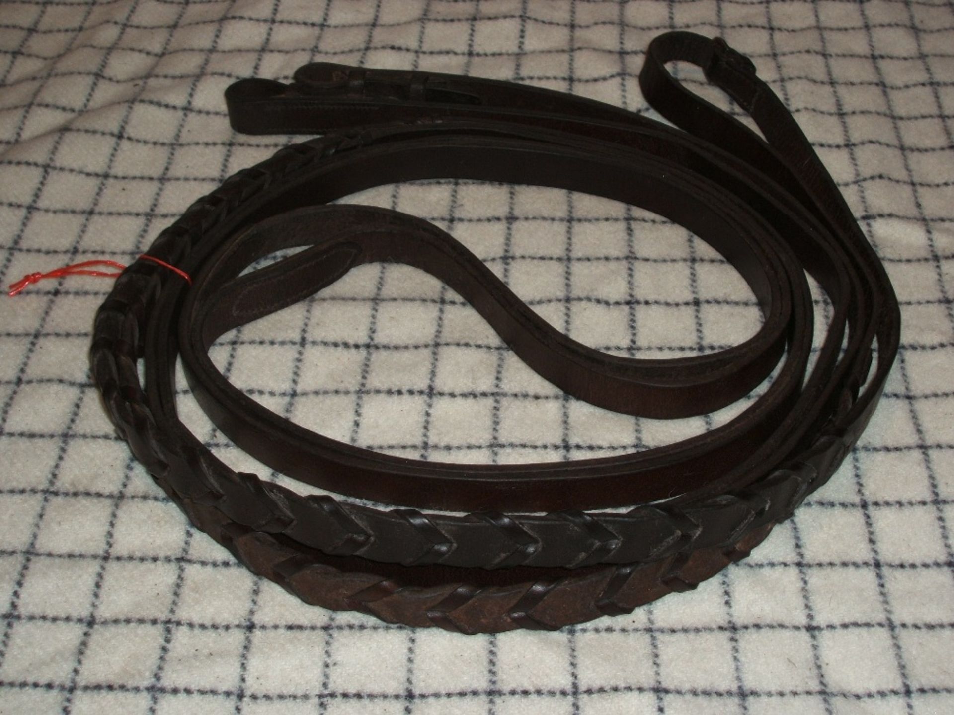 Pair of cob size brown leather laced driving reins