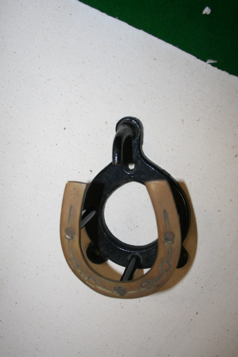 Bridle bracket with a brass horseshoe front