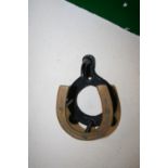 Bridle bracket with a brass horseshoe front