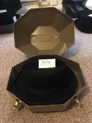 Black trilby hat with a hat box