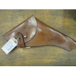 A WW1 leather pistol holster dated 1917, complete with the original brass cleaning rod. In good