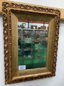 Gilt ornately framed wall mirror, 67 x 50cms. Estimate £10-20