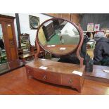 Walnut toilet mirror on shaped supports and three frieze drawers. Estimate £20-30.