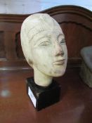 Egyptian sandstone carved burial head mounted on wood stand. Estimate £20-50.