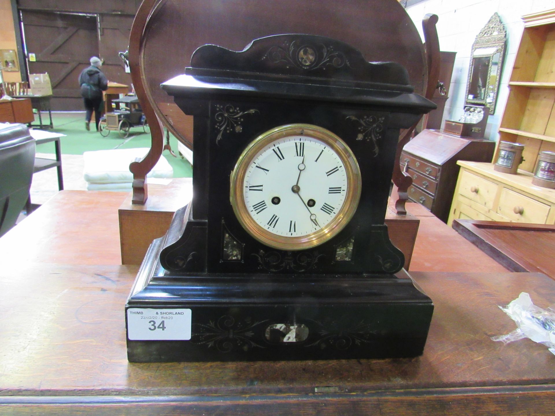 Polished slate mantel clock with marble inserts. 2 drum movement. Going order. Estimate £40-50.