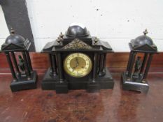 Slate clock set with two figurines garnitures. Height of clock: 32cms. Estimate £40-60.