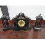 Slate clock set with two figurines garnitures. Height of clock: 32cms. Estimate £40-60.