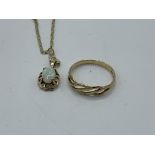 9ct gold band ring with open work to front, size K, weight 1.0gm. 9ct gold and opal pendant on a 9ct