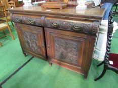 Oak sideboard with carved drawers and cupboard doors, 137 x 53 x 98cms. Estimate £20-40.