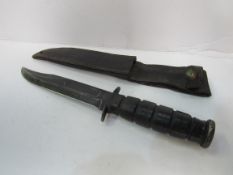 US Marine Corps KA-BAR knife complete with leather scabbard. Estimate £20-40.