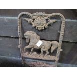 Cast iron plaque depicting a horse. Estimate £30-50.