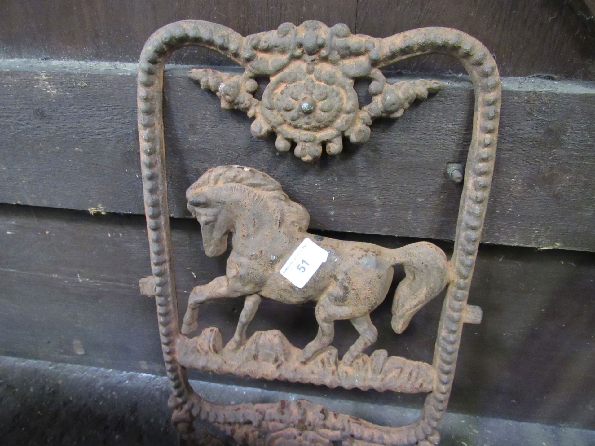 Cast iron plaque depicting a horse. Estimate £30-50.